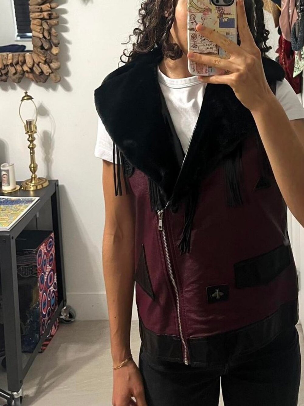 Burgundy and black fake leather vest with black fur around the collar and black